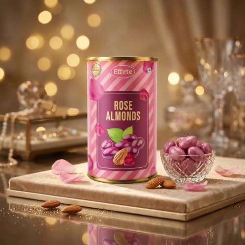 A pink and purple tin of rose almonds stands next to a small glass bowl filled with purple almonds, with loose almonds and