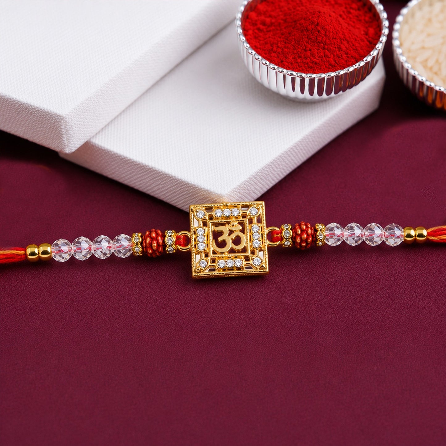 Four Om Symbol AD Rudraksha Rakhis in a gift box for Raksha Bandhan.