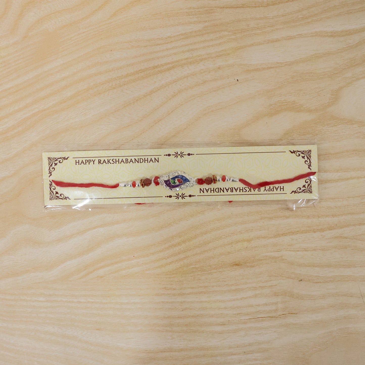 Morpich Enamel Rakhi with Silver Beads and Red Thread