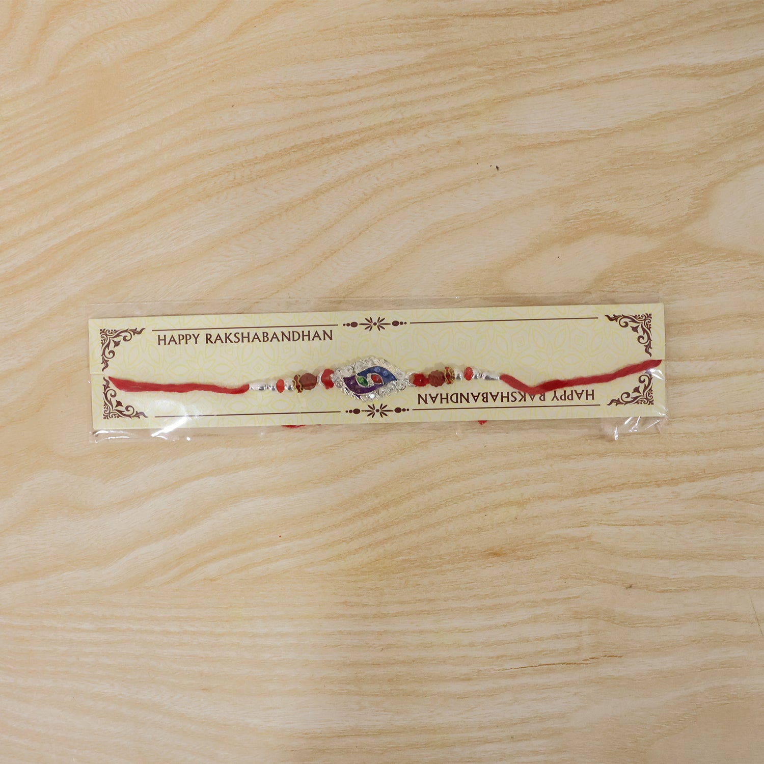 Morpich Enamel Rakhi with Silver Beads and Red Thread
