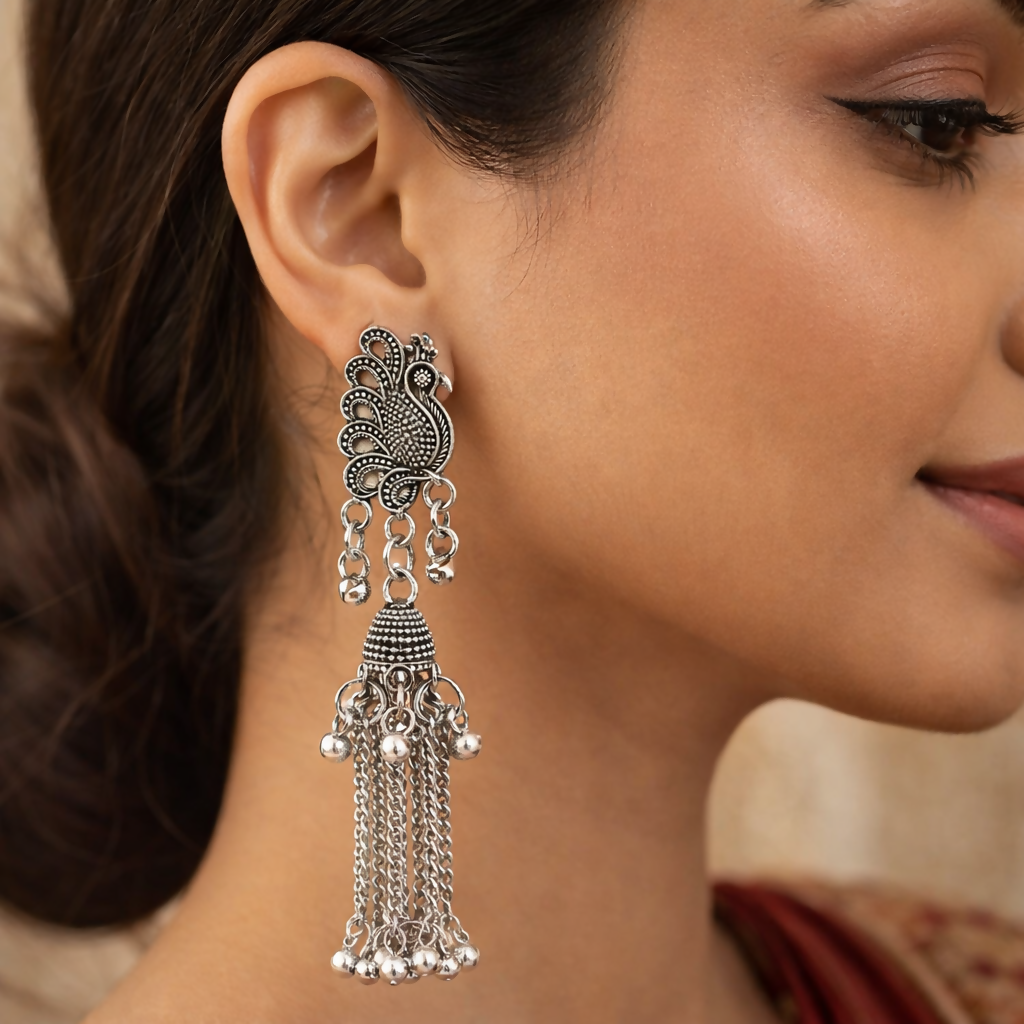 Close-up of oxidised silver peacock motif on jhumka earrings