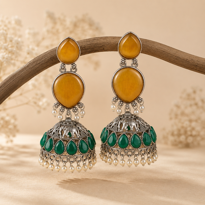 Traditional jhumka earrings with elephant motifs and emerald green stones