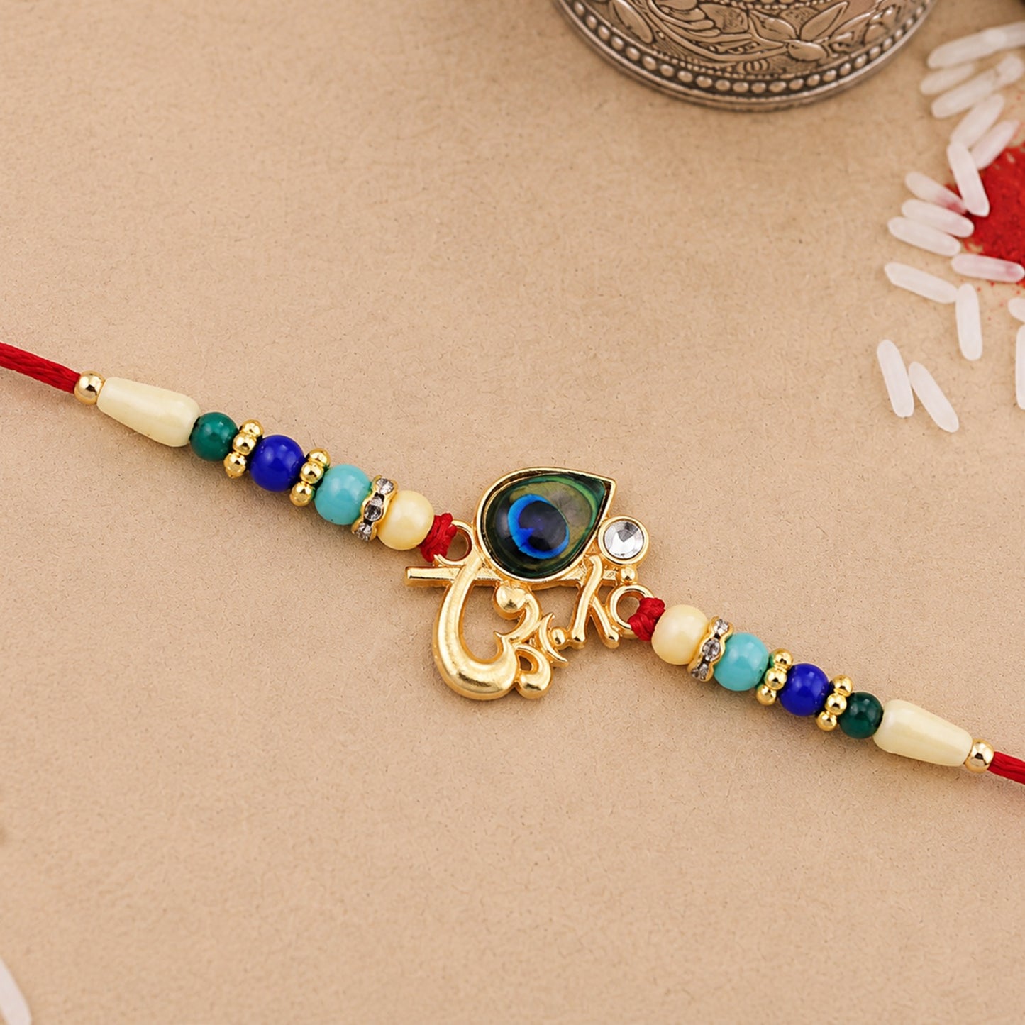 Detailed Peacock Feather Rakhi with vibrant multicolor beads and golden accents