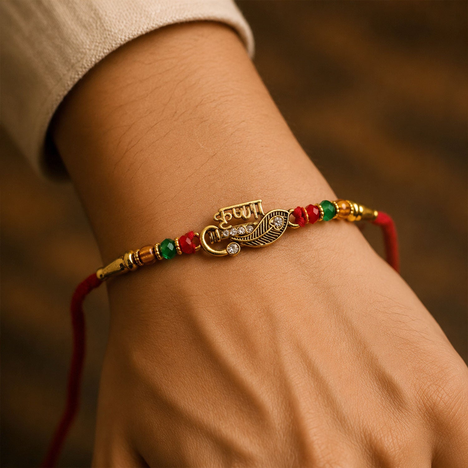 Veera Name Rakhi with Flute Leaf Style Centre, Stones and Red Green Beads