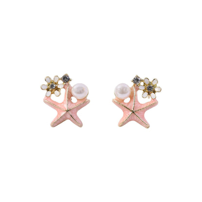 Pink starfish pearl stud earrings on white background