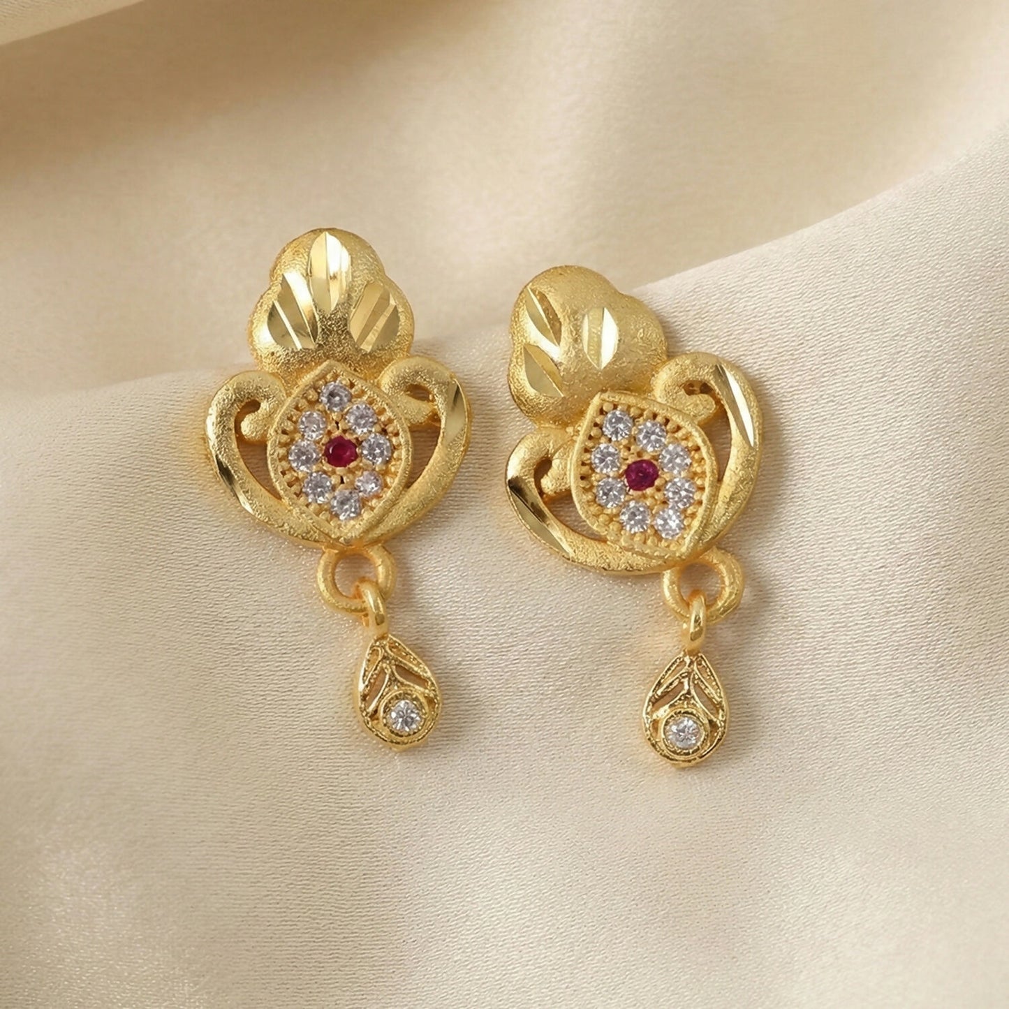 Ethnic Floral Motif Gold Stud Earrings With Stone Center And Elegant Drop Finish
