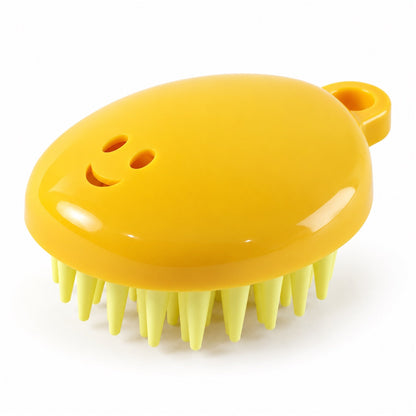 A yellow silicone scalp brush with light green bristles and a smiley face design is shown on a white background.
