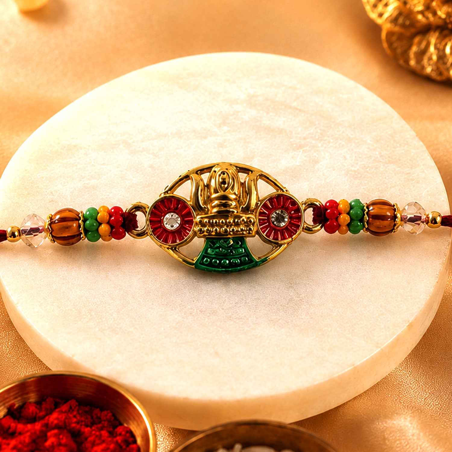 Golden Kalash Temple Devotional Rakhi with Red Green Details and Festive Beads