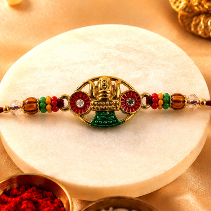 Golden Kalash Temple Devotional Rakhi with Red Green Details and Festive Beads