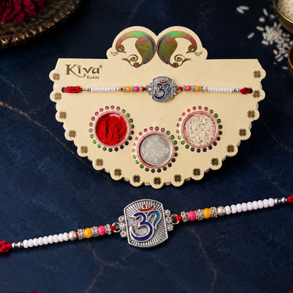 Om Symbol Silver Centre Rakhi with White Beads, Roli Chawal Coin and Peacock Gift Packing