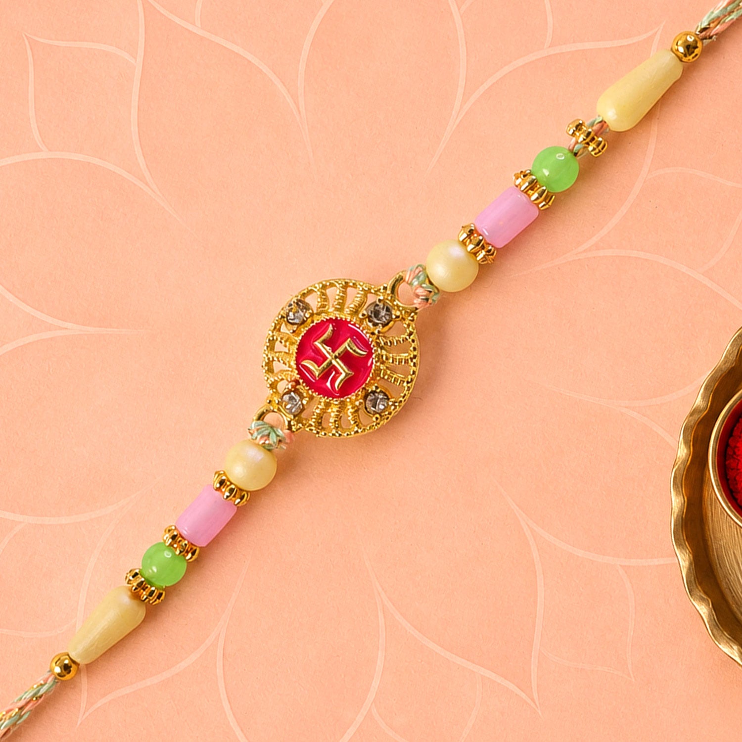 Swastik Pendant Rakhi with Kundan Stones and Pastel Beads