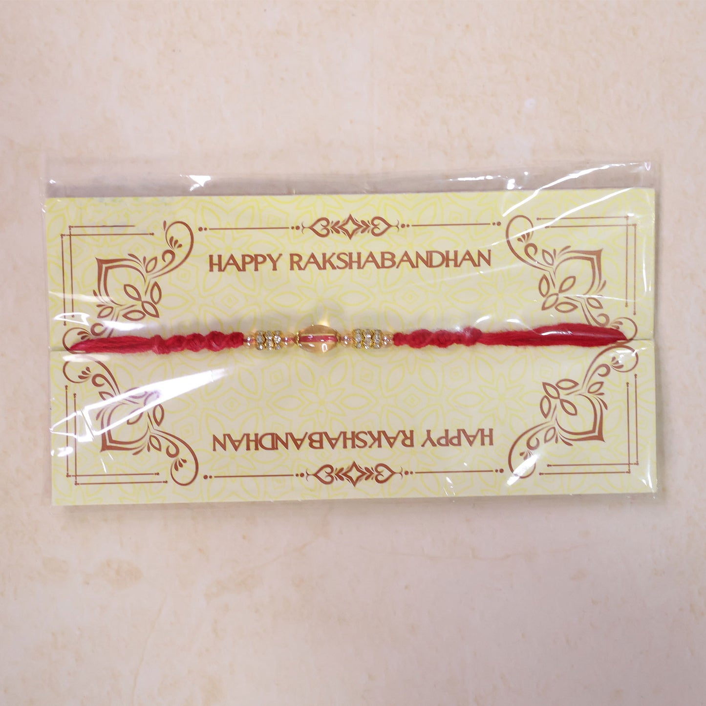 Red Twisted Cord Rakhi with Crystal Bead and Golden Accents