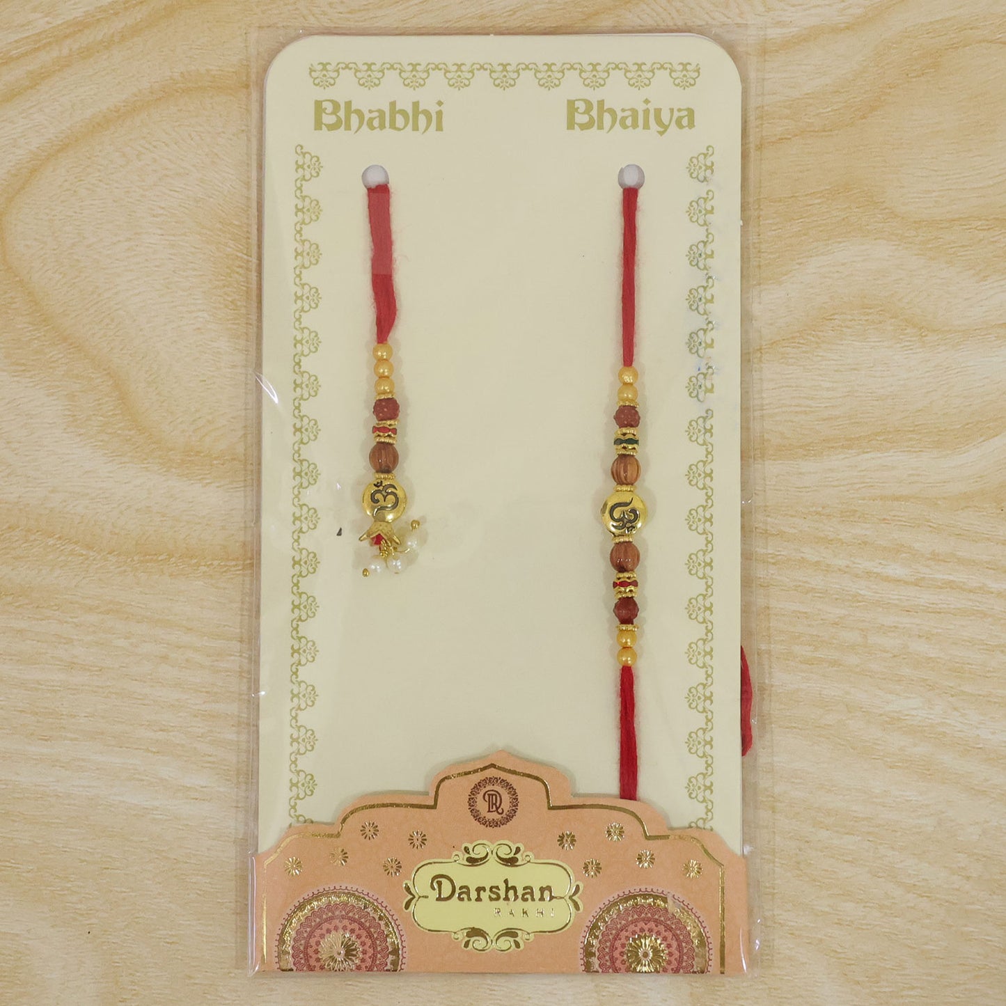 Om Motif Bhai Bhabhi Rakhi with Rudraksha Beads, Wooden Beads and Pearl Drop Charms