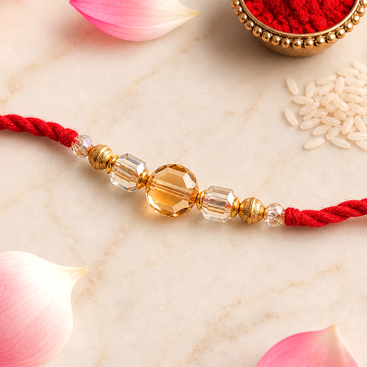 Red Thread Rakhi with Golden and Sparkling Crystal Bead Accents