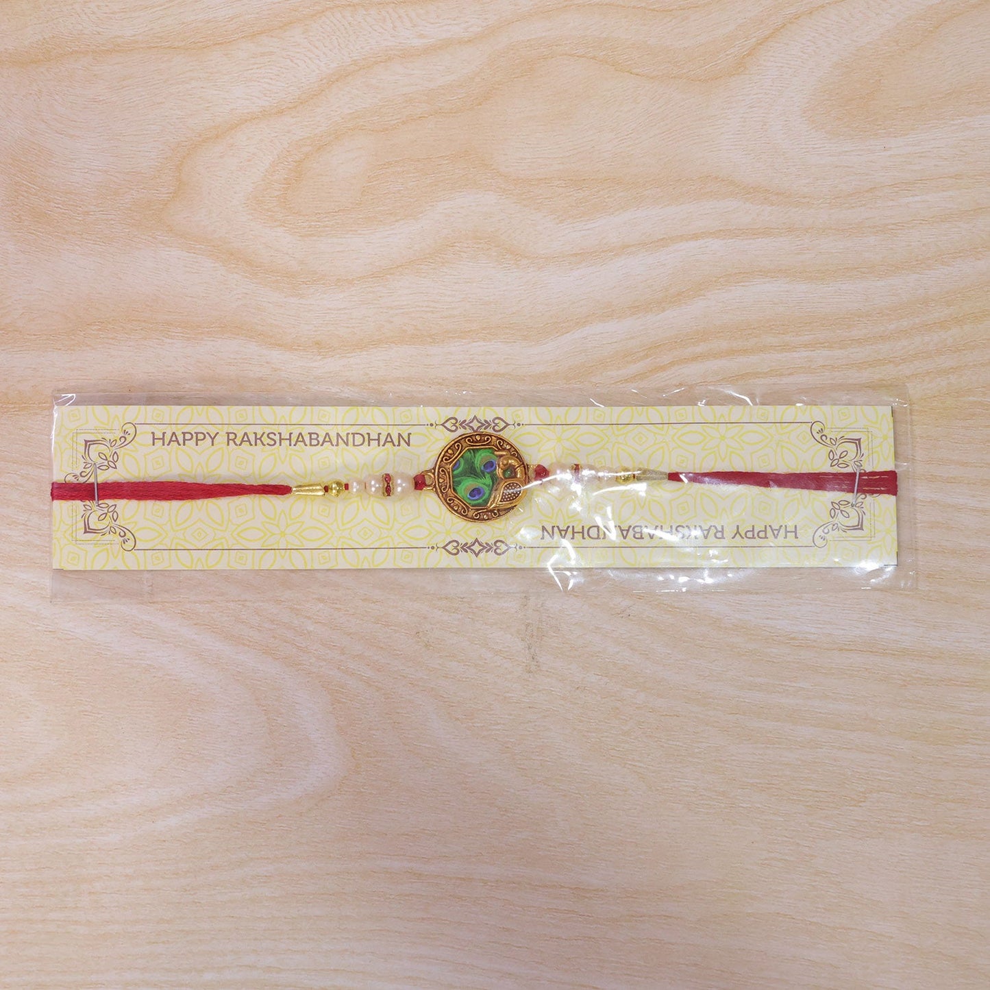 Shop Peacock Feather Rakhi with Pearl Bead Accents Red Thread (5pcs)