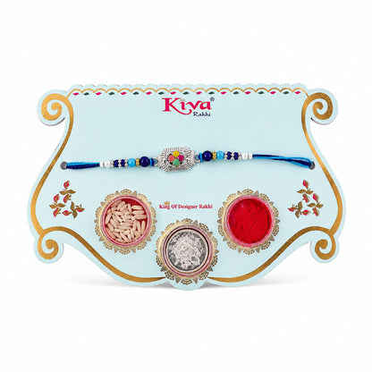 Silver Floral Stone Rakhi with Royal Blue Thread, Roli Chawal Coin and Card Gift Packing