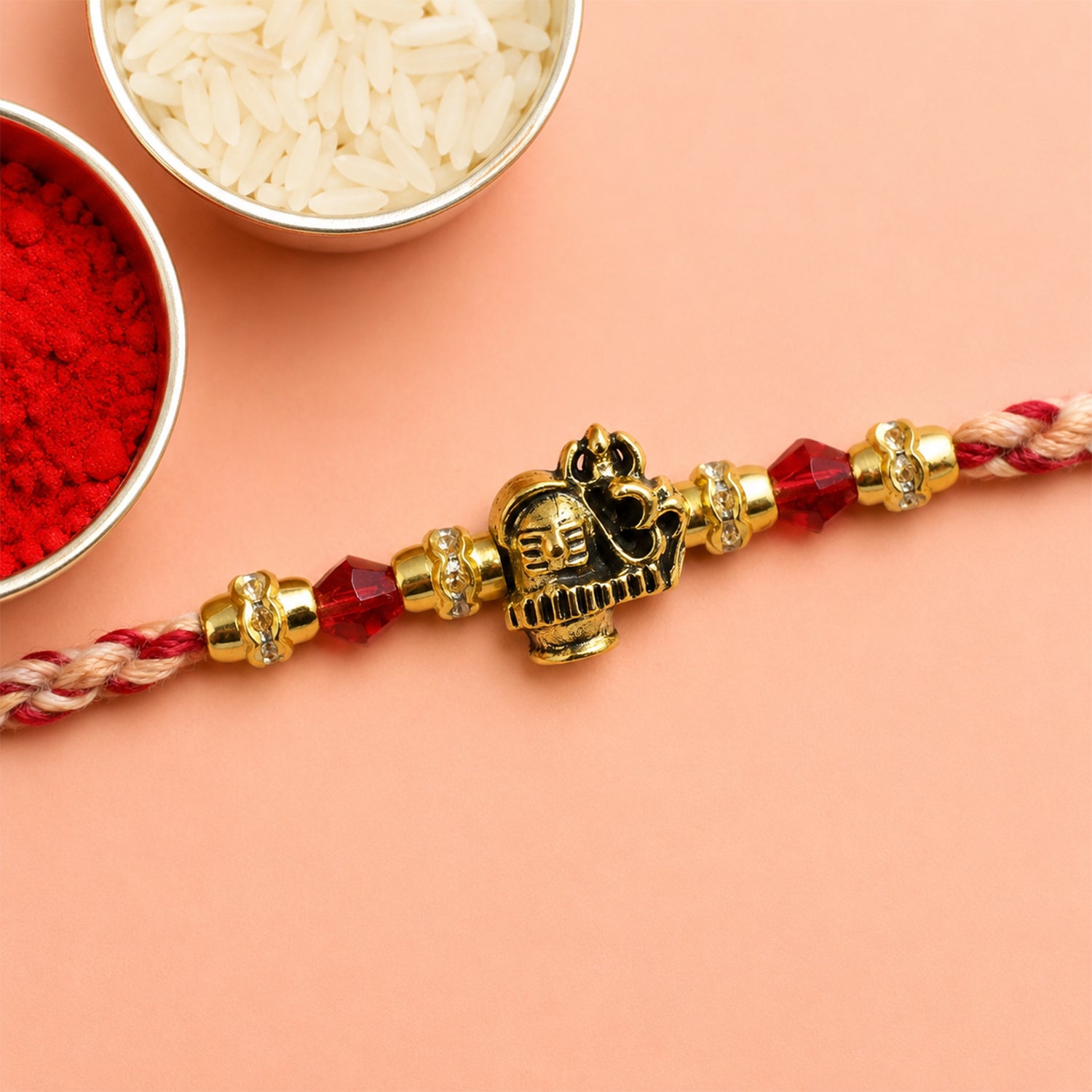 Sacred Deity Rakhi with Red-Beige Thread and Gold Pendant for Raksha Bandhan Gift