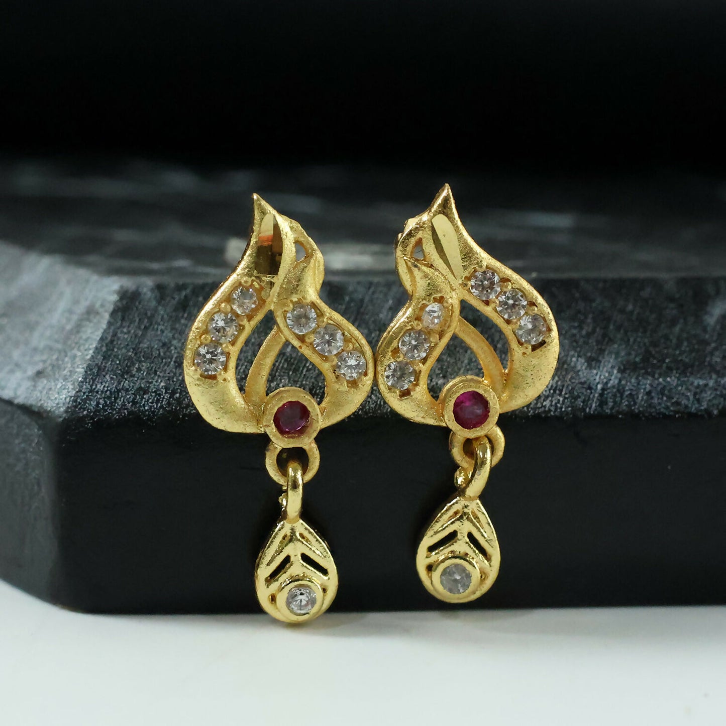 Classic Gold Tone Designer Leaf Earrings With Ruby Accent And Graceful Hanging Drop