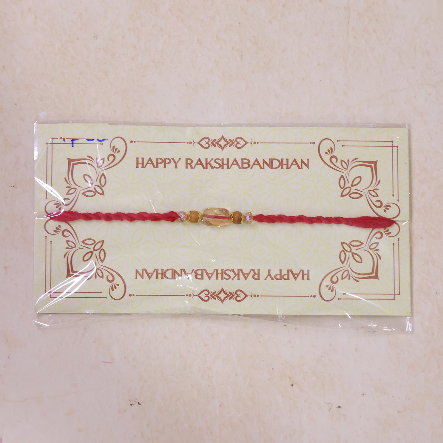 Red Thread Rakhi with Wooden and Sparkling Crystal Bead Pendant