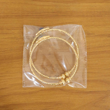 Elegant gold evil eye bangles with blue eye detail arranged artistically