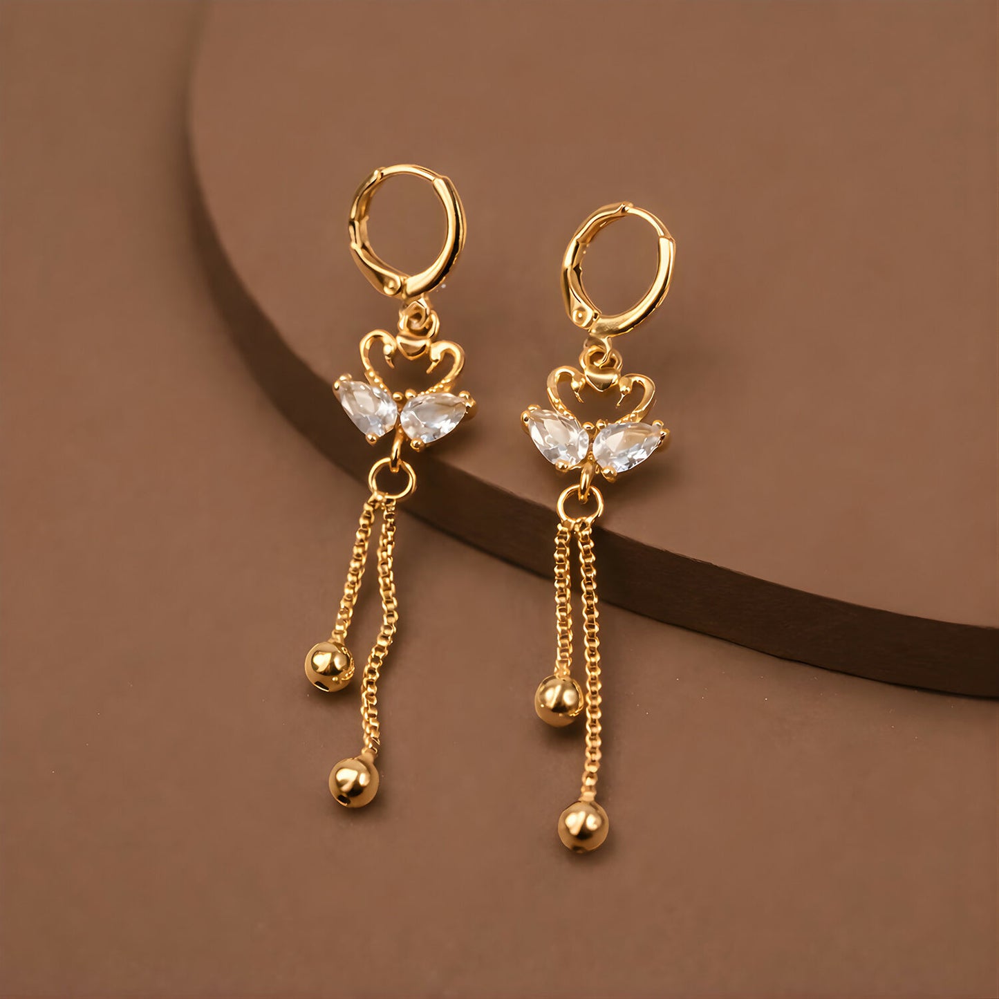 Elegant swan-shaped drop earrings with shimmering crystals and gold finish