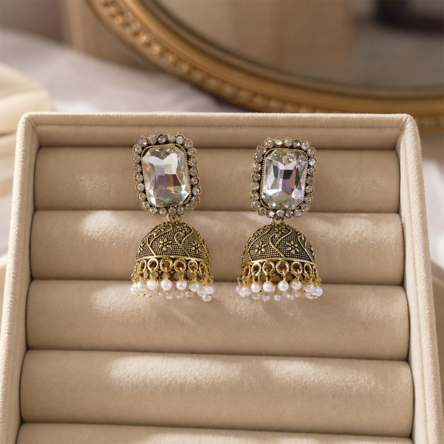 Antique gold dome with white stone detailing on jhumka earrings