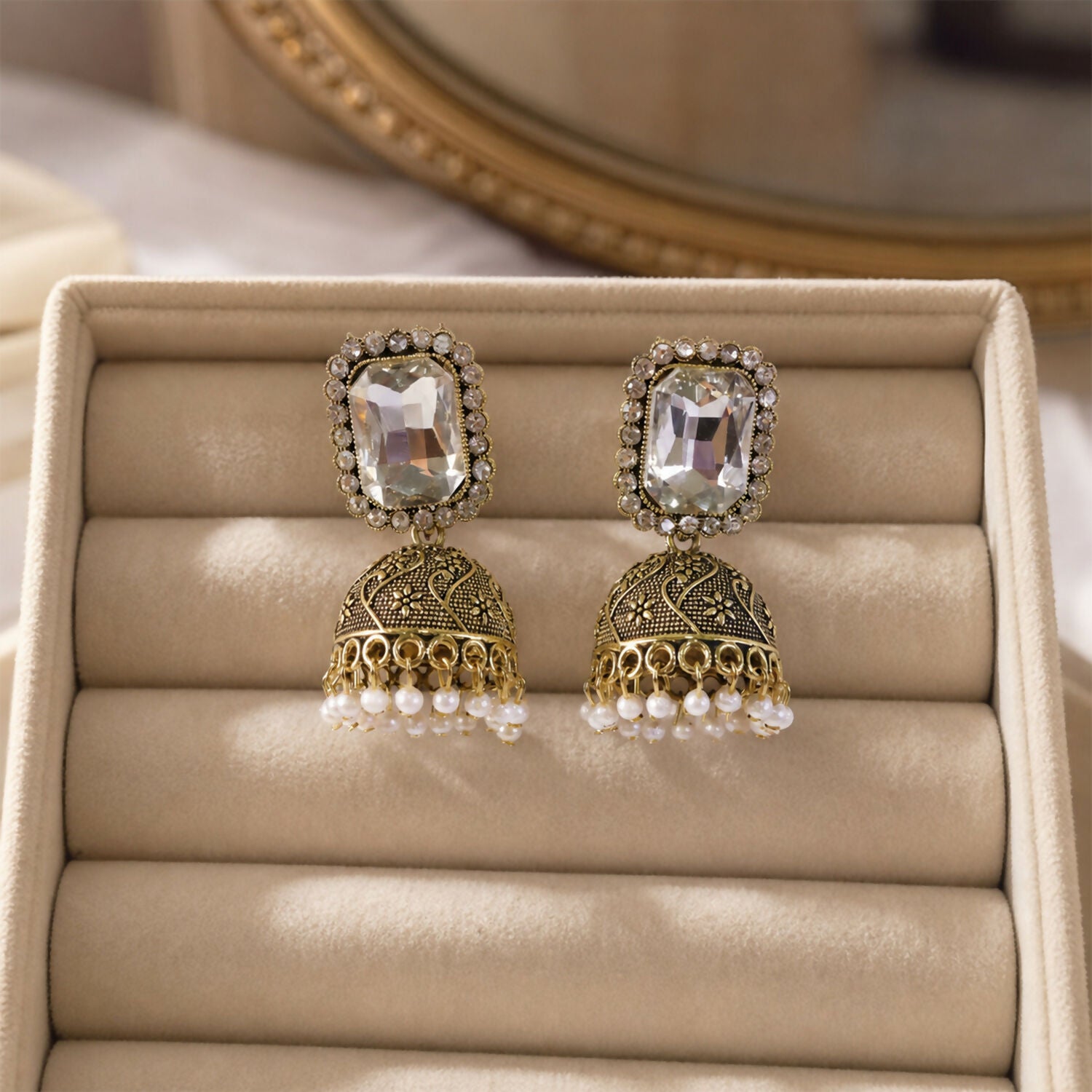 Antique gold dome with white stone detailing on jhumka earrings