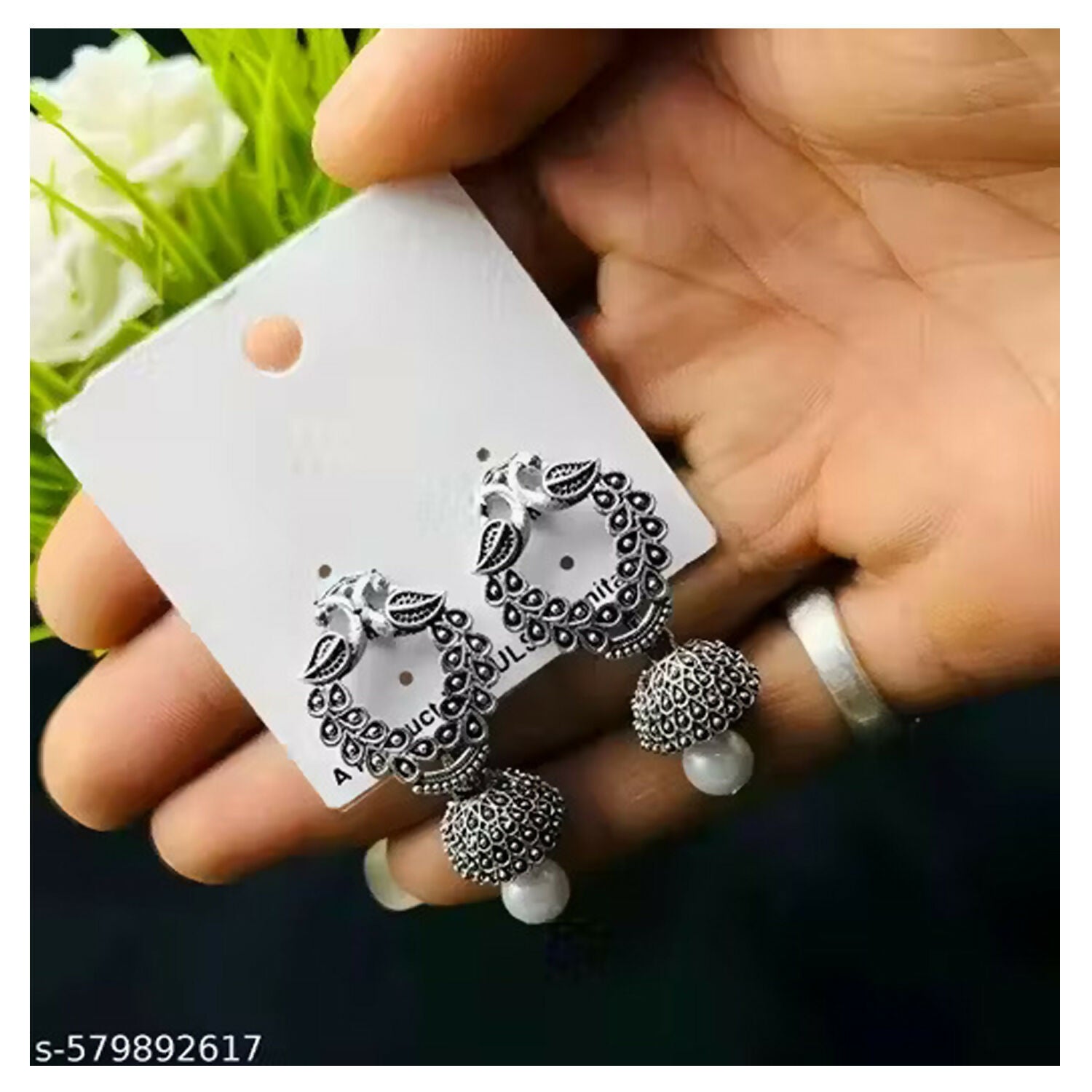 Close-up view of silver oxidised small jhumki earrings