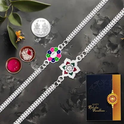 Rakhi Gift Combo with 2 Stylish Floral Rakhis for Brother – Includes Silver Coin, Roli Chawal & Greeting Card