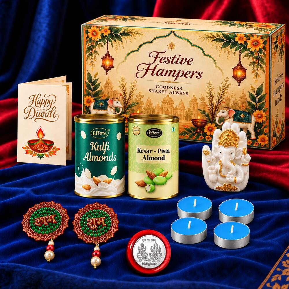 A Diwali gift box, Ganesha idol, almond tins, tealights, and earrings are displayed on a blue fabric surface.