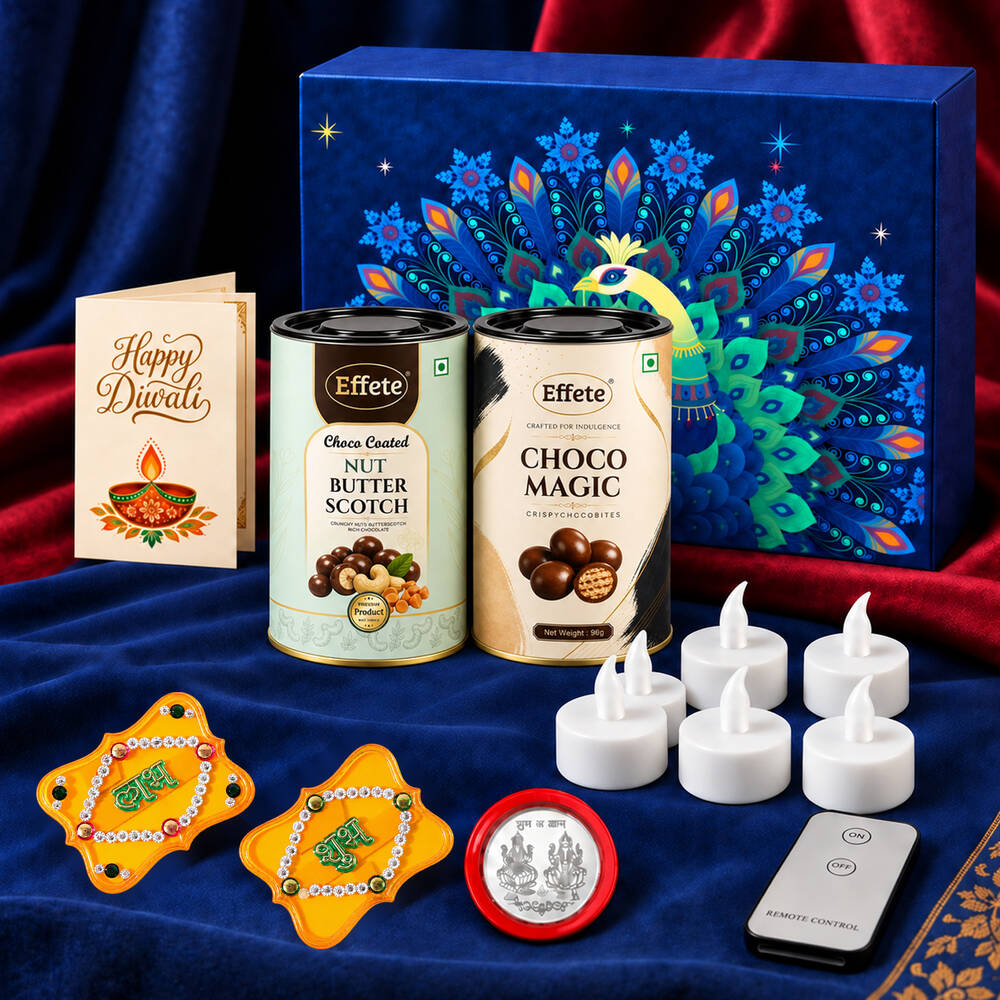 A blue velvet cloth displays a Diwali gift box, two chocolate tins, a greeting card, six LED tealights, a remote, two Shubh
