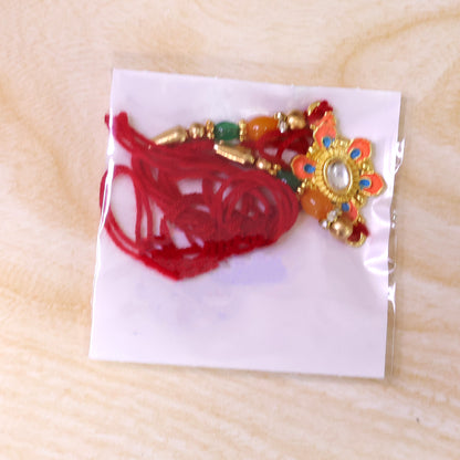 Orange and Teal Floral Kundan Pendant Rakhi with Pastel Beads