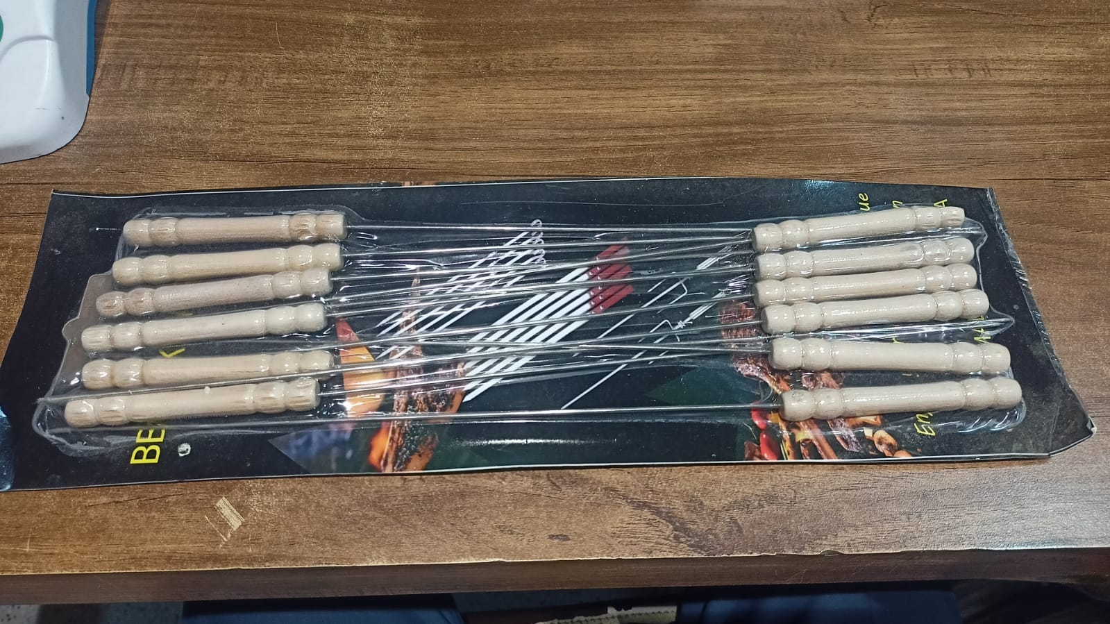 BBQ skewers with cooked meats and vegetables served on plate