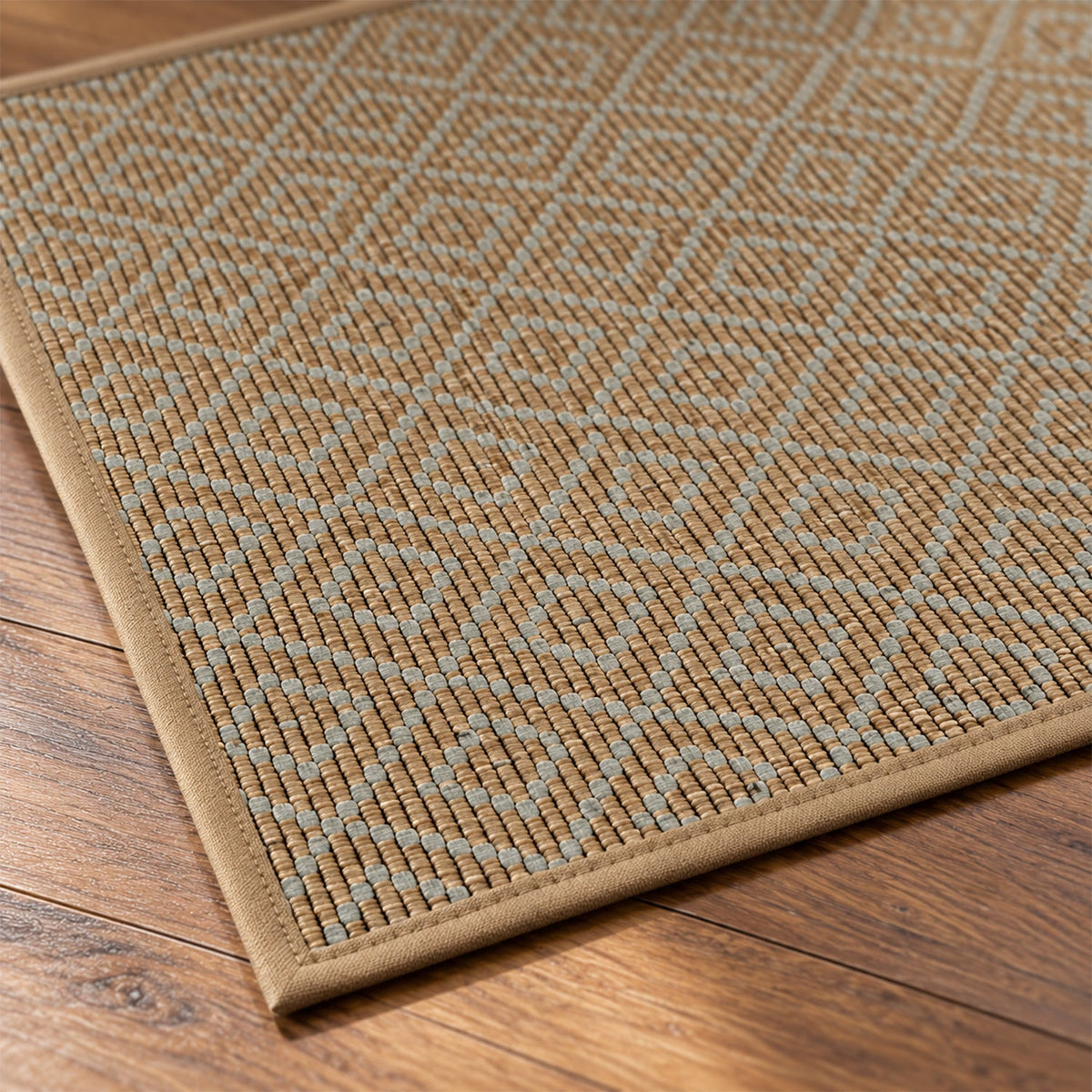 A close-up view reveals the intricate diamond woven texture and stitched edge of the brown runner mat on wood.
