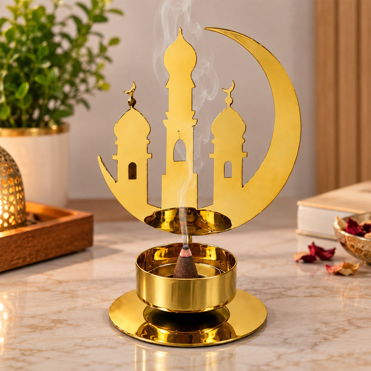A golden metal incense holder with a crescent moon and mosque design, emitting smoke from a brown cone.