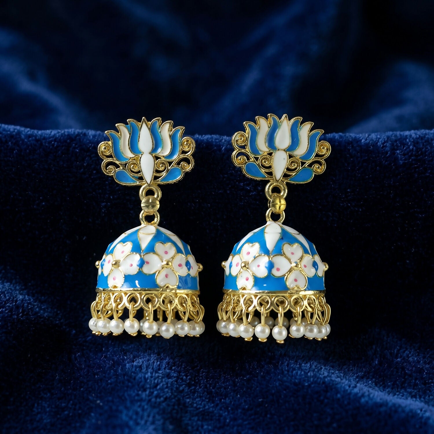 Detailed shot of intricate golden and blue design on earrings