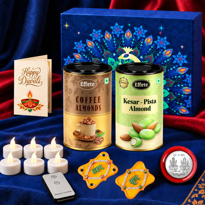 A blue peacock-themed gift box, two almond tins, a Diwali card, six LED tealights, a remote, two yellow Shubh Labh
