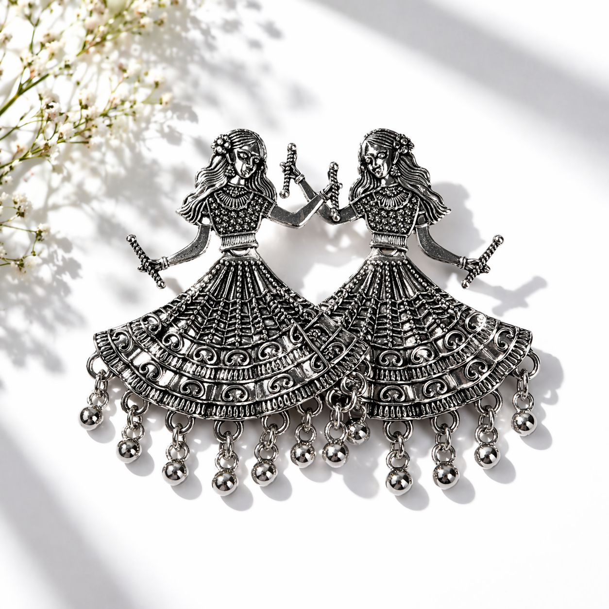 Traditional Dandiya earrings featuring ethnic motifs with oxidized silver finish