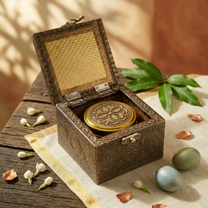 Metallic-lidded glass jar alongside brass keepsake box