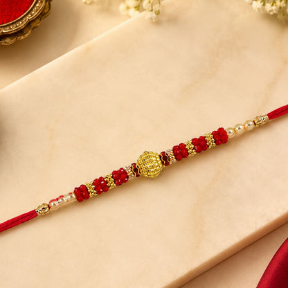 Beautiful Red Bead Rakhi with golden centerpiece and pearl accents for brothers.