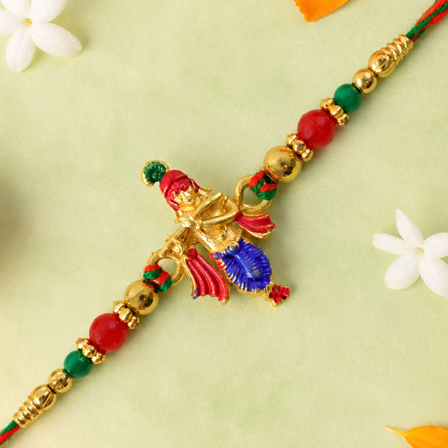 Lord Krishna Flute Pendant Rakhi with Red and Green Beads