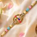 Colorful Circular Charm Rakhi with Pink Blue Beads and Festive Brother Gift Appeal