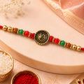Ganesha Golden Medallion Rakhi – Red Green Beads & Festive Thread