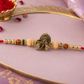 Krishna Flute Peacock Rakhi – Devotional Design with Peach Beads