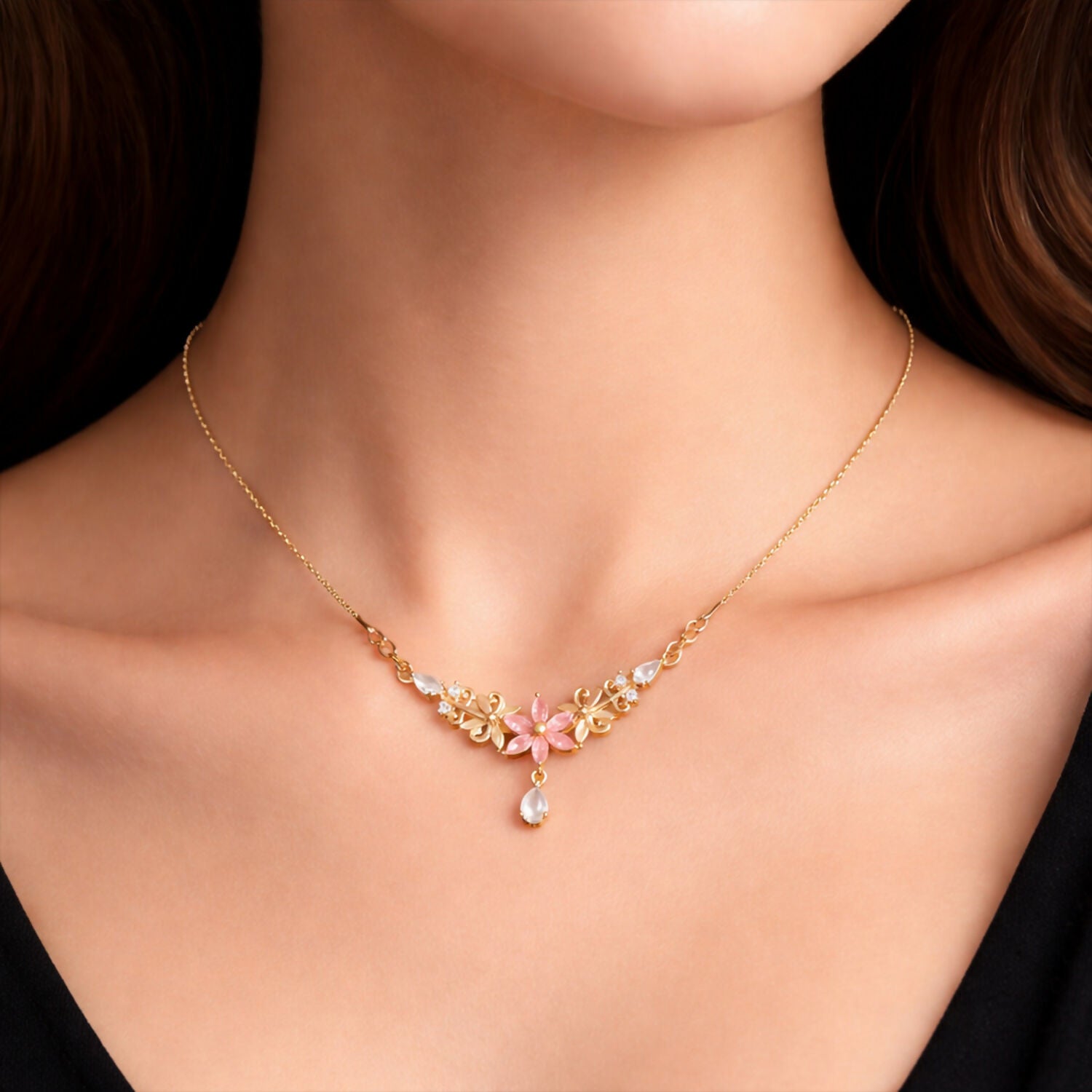 Pink floral pendant necklace with elegant gold finish and crystal drop displayed beautifully