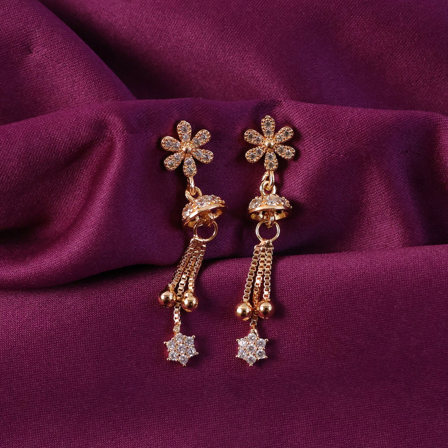 Elegant rose gold drop earrings sparkling in light with floral charm