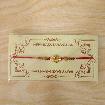 Tilak Trishul Golden Devotional Rakhi with Wooden Beads and Traditional Red Thread