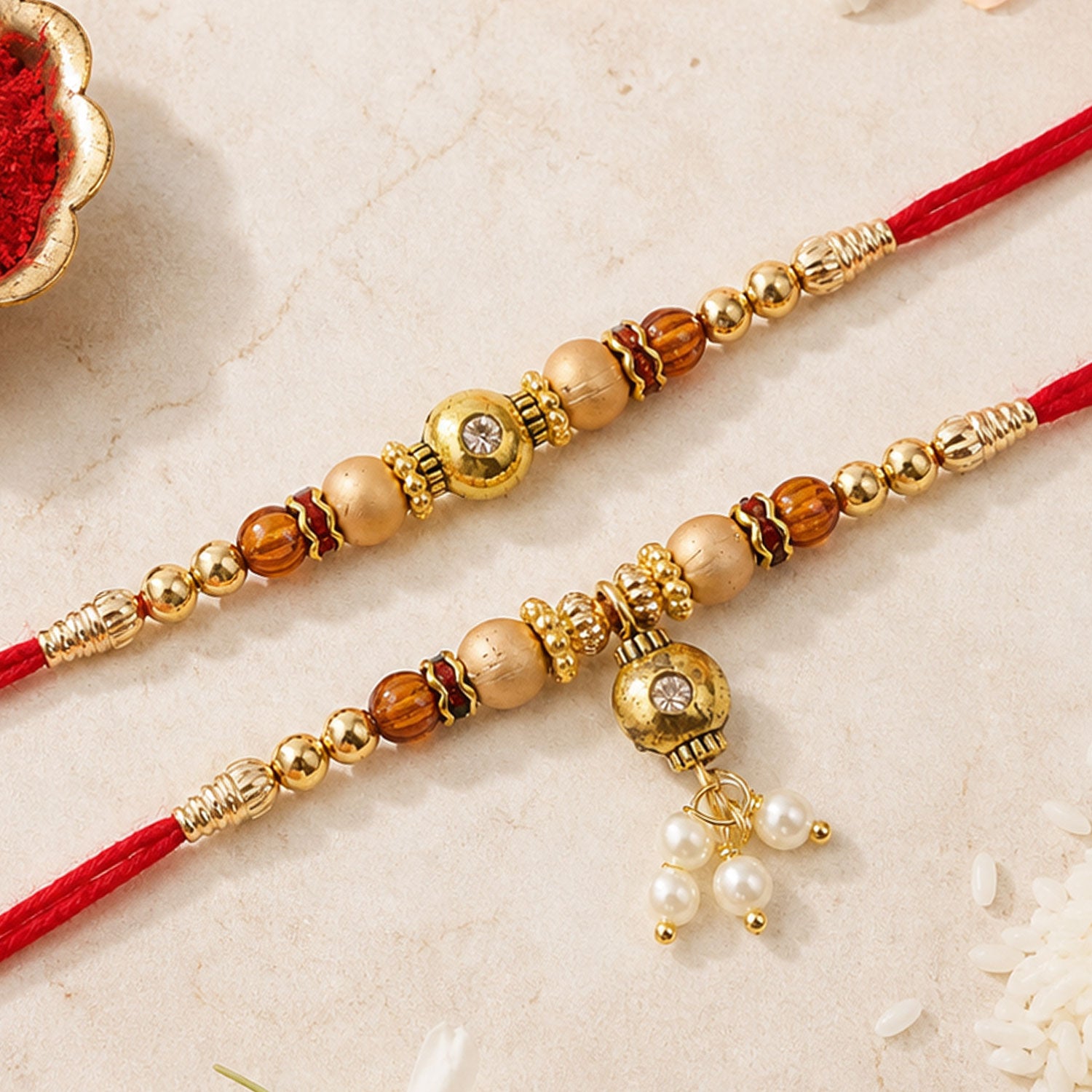 Bhai Bhabhi Kundan Rakhi Set with Red Thread, Gold Beads and Pearl Drop Accent Design
