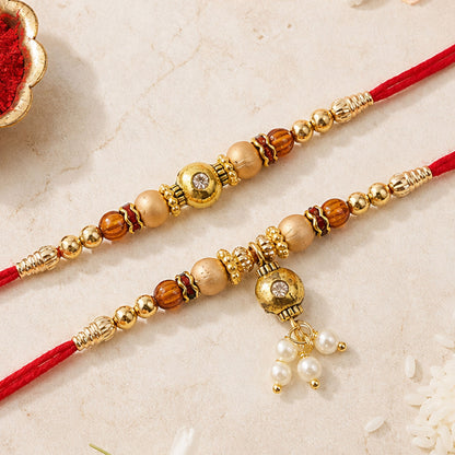 Bhai Bhabhi Kundan Rakhi Set with Red Thread, Gold Beads and Pearl Drop Accent Design