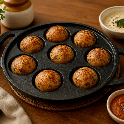 Close-up of cast iron appam patra cavities and handles
